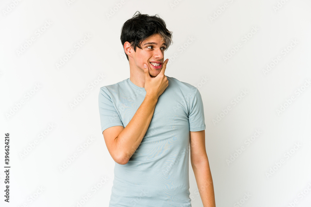 Young skinny hispanic man touching back of head, thinking and making a choice. Young skinny hispanic man touching back of head, thinking and making a choice.