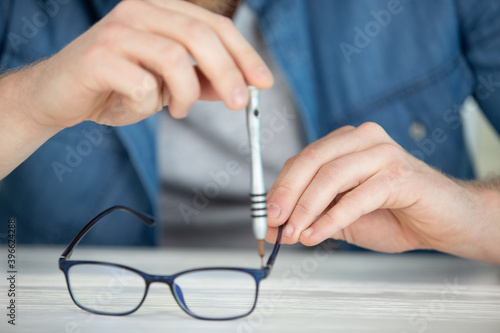 woman repairing glasses with screwdriver