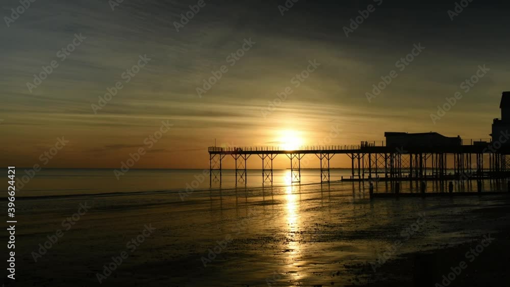 Time Lapse a beautiful sunset with reflections on the water and sand by the Pier at Bognor Regis Time Lapse a beautiful sunset with reflections on the water and sand by the Pier at Bognor Regis