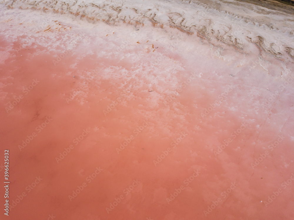 Aerial top view to pink salt lake. Photo from drone. Pink nature background. Sasyk-Sivash pink salt lake in Crimea.