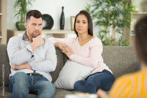young fighting angry couple discussing with psychologist