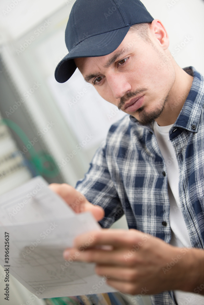 young serious workman reading instructions young serious workman reading instructions