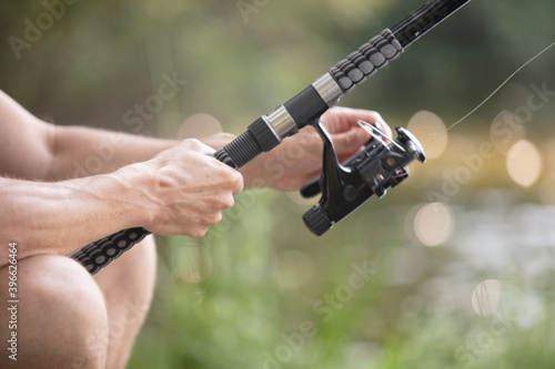 close up of a fishing rod with man hands