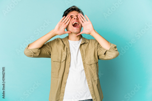 Young caucasian skinny man expressing emotions isolated on blue background