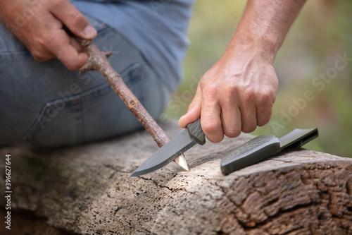 cropped image of man whittling a stick