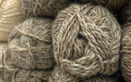 Balls of wool for knitting. Brown fluffy yarn.