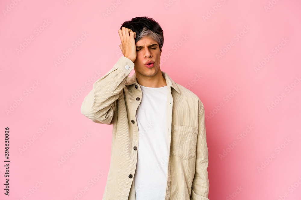 Young skinny hispanic man tired and very sleepy keeping hand on head. Young skinny hispanic man tired and very sleepy keeping hand on head.