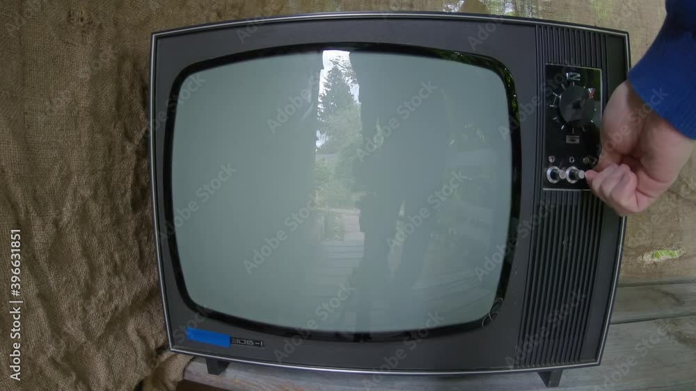 Man hand turns on an old retro TV, the device screen is static noise. Man switches programs, but the interference continues. Man turns off the TV Man hand turns on an old retro TV, the device screen is static noise. Man switches programs, but the interference continues. Man turns off the TV