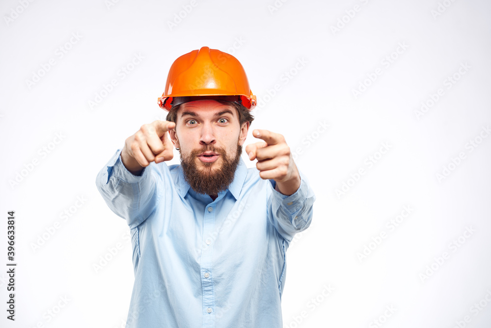 Engineers shirt orange hard hat construction lifestyle emotions cropped view light background