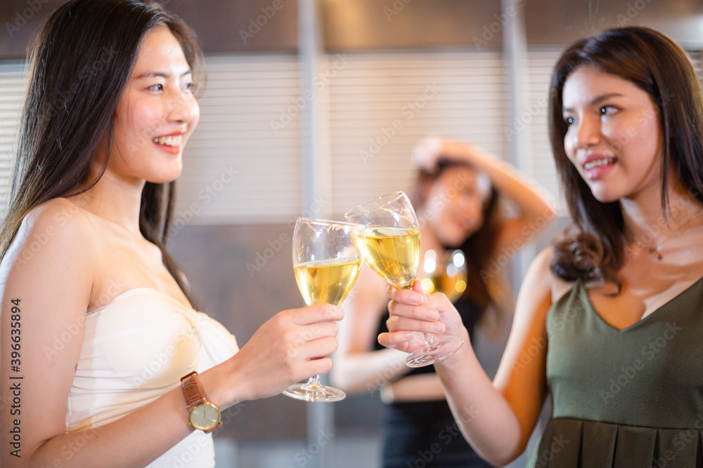 Asian beautiful woman cheers and toasting glass of wine together. clubbing and celebrating with best friend and having party at night. people lifestyle concept Asian beautiful woman cheers and toasting glass of wine together. clubbing and celebrating with best friend and having party at night. people lifestyle concept