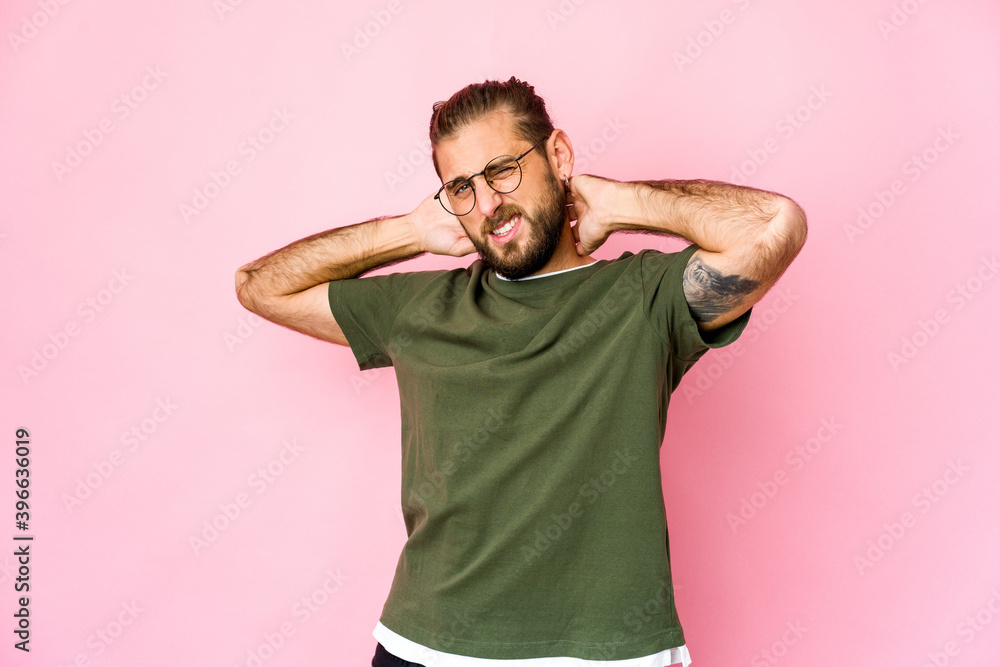 Young man with long hair look touching back of head, thinking and making a choice. Young man with long hair look touching back of head, thinking and making a choice.