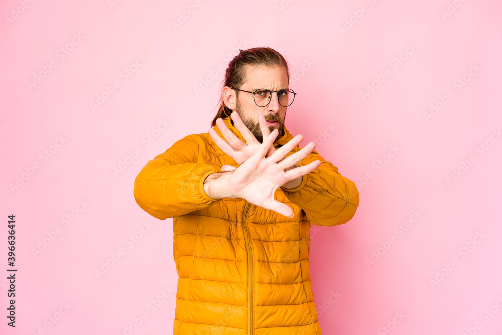 Young man with long hair look doing a denial gesture Young man with long hair look doing a denial gesture
