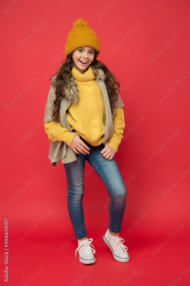 Feeling playful. happy childhood. cold season look for teen girl. knitted  clothing style. take care of health. cheerful child wear warm winter clothes.  seasonal kid fashion. stay cozy and comfortable Stock Photo