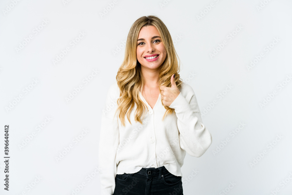 Young caucasian blonde woman smiling and raising thumb up Young caucasian blonde woman smiling and raising thumb up