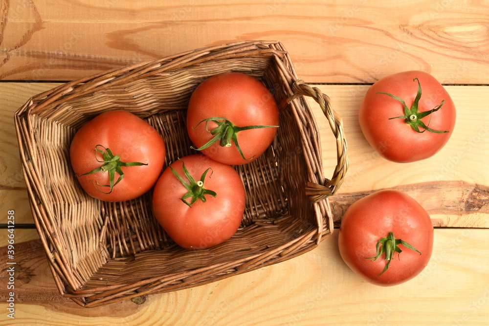 Ripe pink tomatoes, close-up, on a white wooden table. Ripe pink tomatoes, close-up, on a white wooden table.