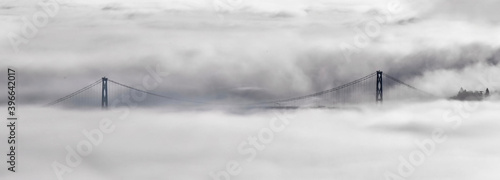 Lions Gate Bridge and Vancouver skyline in foggy morning in winter. Scenic view from Cypress Mountain. North Vancouver. British Columbia. Canada.