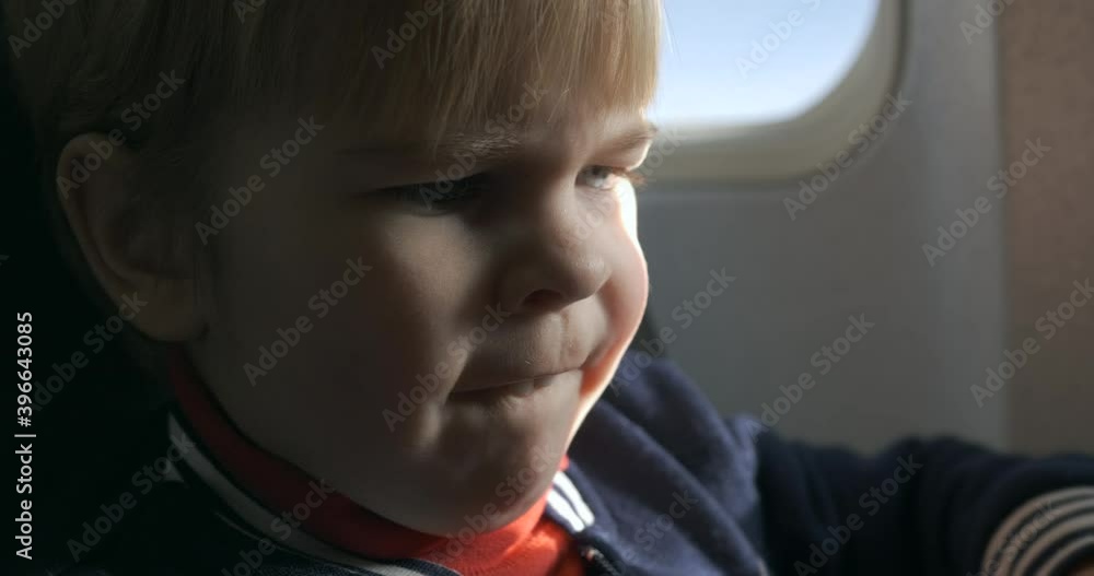 Little Boy Reads Watching Menu Book in Passenger Seat on Board in Airplane. Choosing Meal on Board Passenger Jet 4K Little Boy Reads Watching Menu Book in Passenger Seat on Board in Airplane. Choosing Meal on Board Passenger Jet 4K