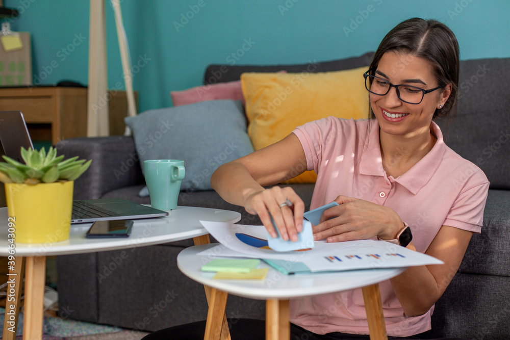 Smiling young woman working remotely from home. Smiling young woman working remotely from home.