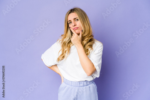 Young caucasian blonde woman contemplating, planning a strategy, thinking about the way of a business.