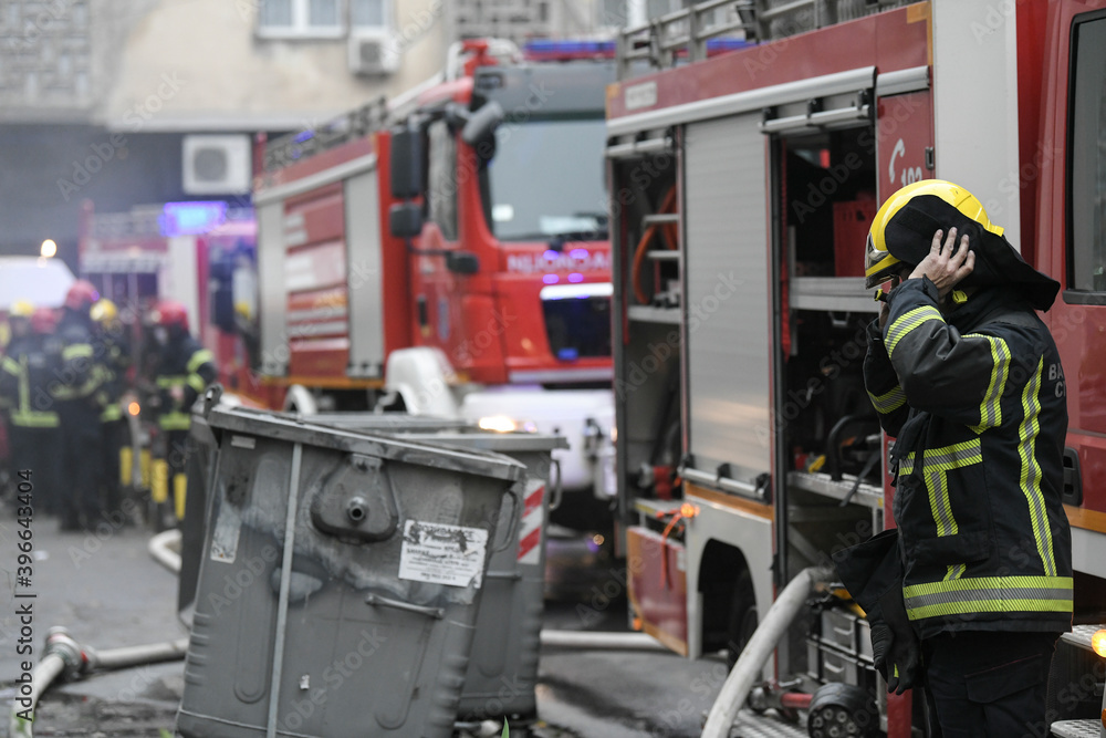 A firefighter puts on a protective suit and helmet before he starts of a rescue mission. A firefighter puts on a protective suit and helmet before he starts of a rescue mission.