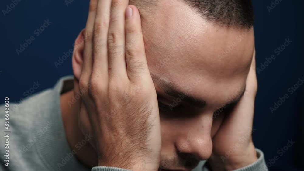 Depressed desperate man feeling worried . Stressed businessman looking frustrated sitting at home Depressed desperate man feeling worried . Stressed businessman looking frustrated sitting at home
