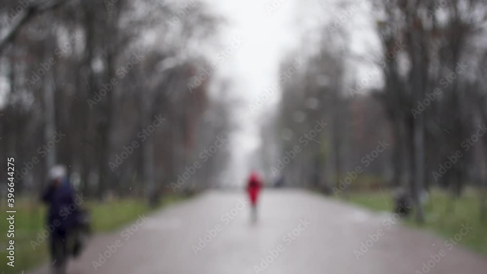 Blurry people walking quickly under snow in winter city. Bokeh 4k video background. Blurry people walking quickly under snow in winter city. Bokeh 4k video background.