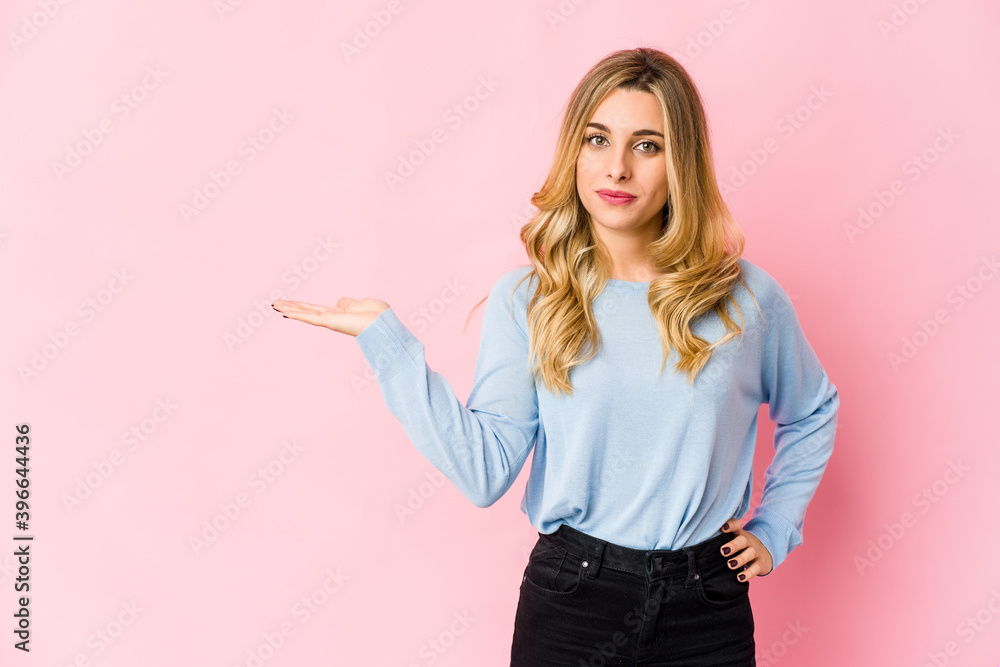 Young caucasian blonde woman pointing to front with fingers. Young caucasian blonde woman pointing to front with fingers.