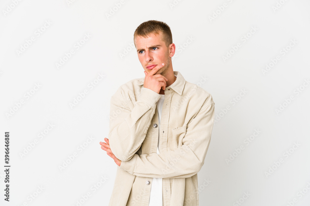 Young caucasian handsome man thinking and looking up, being reflective, contemplating, having a fantasy. Young caucasian handsome man thinking and looking up, being reflective, contemplating, having a fantasy.