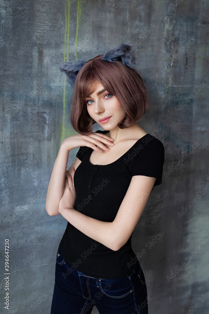 Obraz premium Portrait of a young attractive girl wearing cat ears