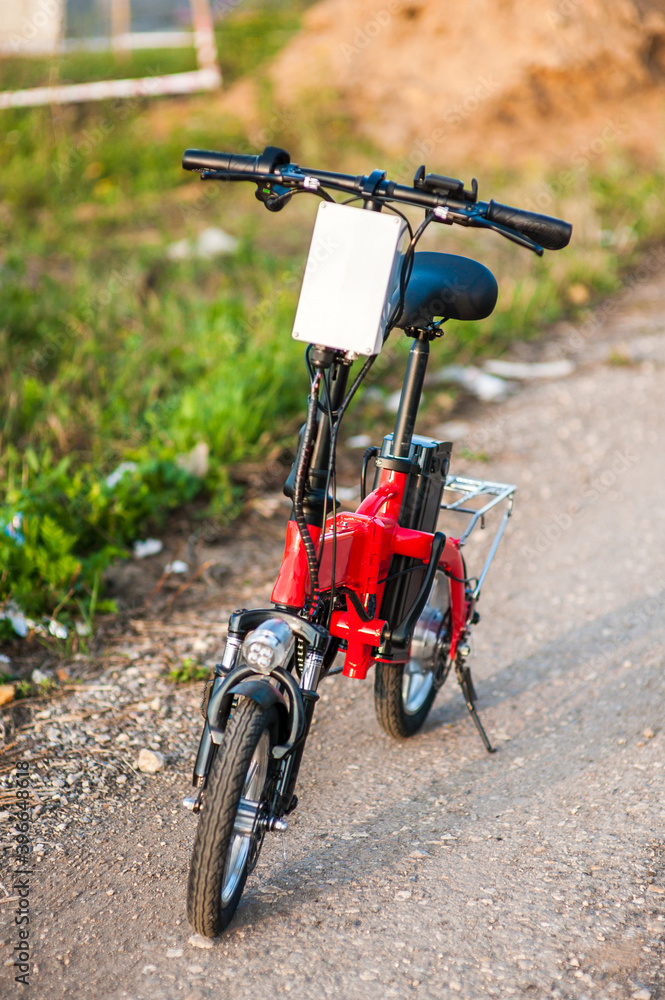 Electric bicycle in the park on sunny summer day. Electric bicycle in the park on sunny summer day.