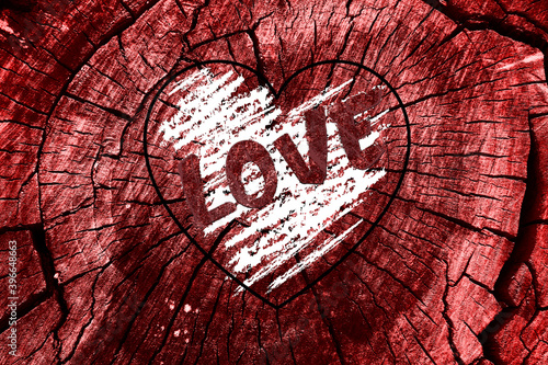 Love. Toned red wood texture. Background with the inscription: Love.