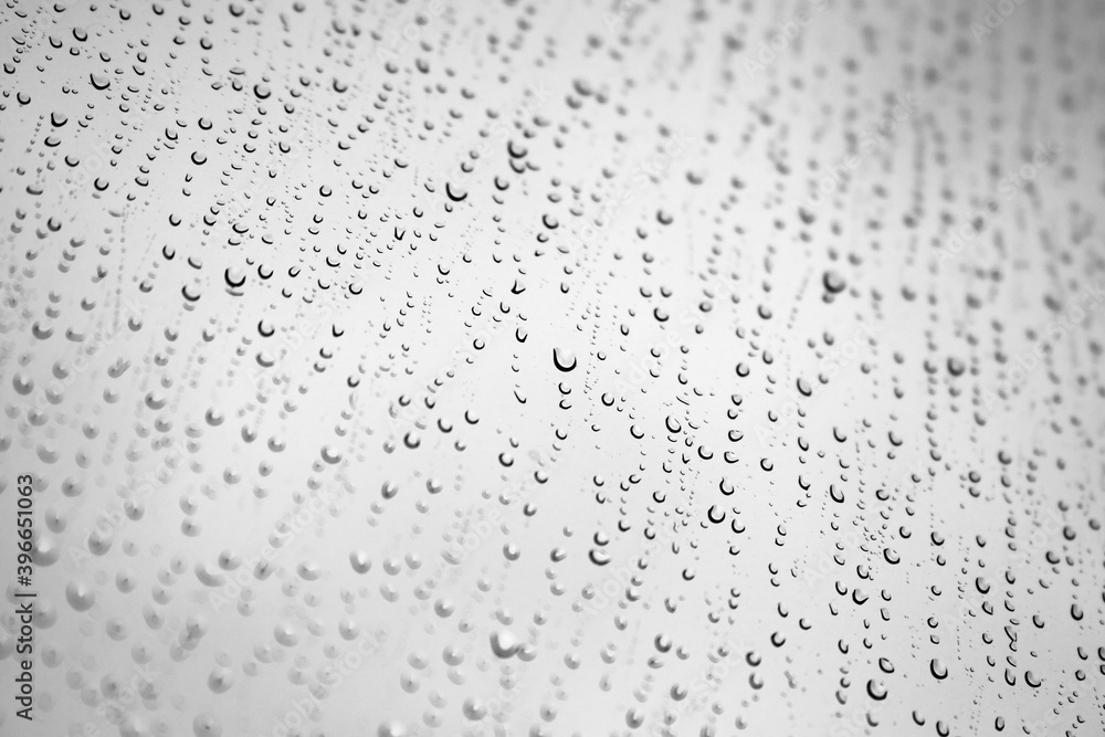 Water drops are on a window glass, background photo Water drops are on a window glass, background photo
