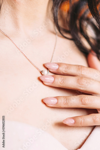 Bride's light pastel manicure with expensive jewelry