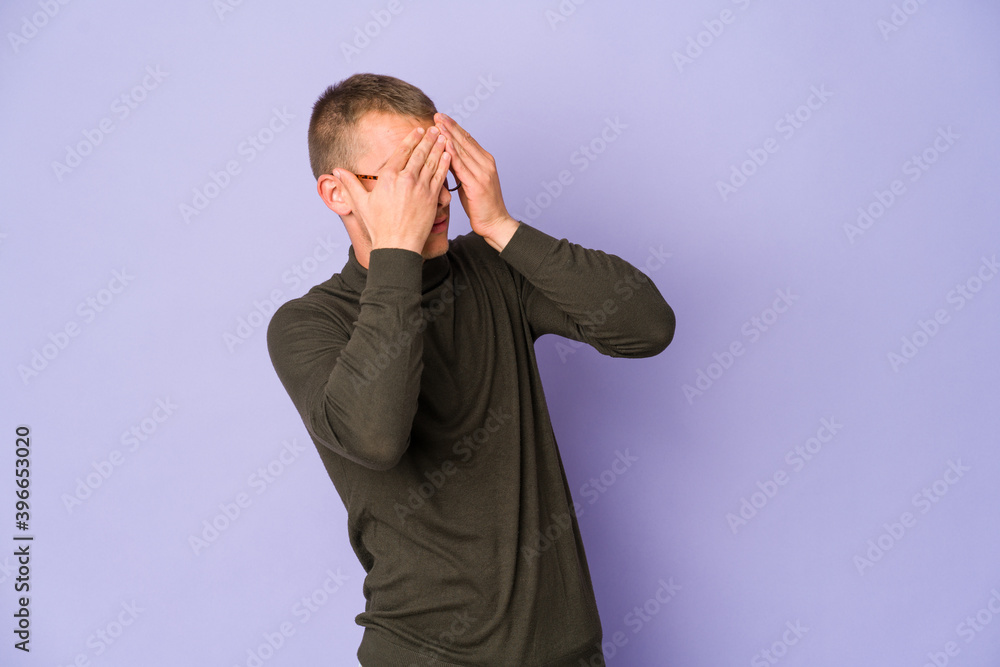 Young caucasian handsome man afraid covering eyes with hands. Young caucasian handsome man afraid covering eyes with hands.