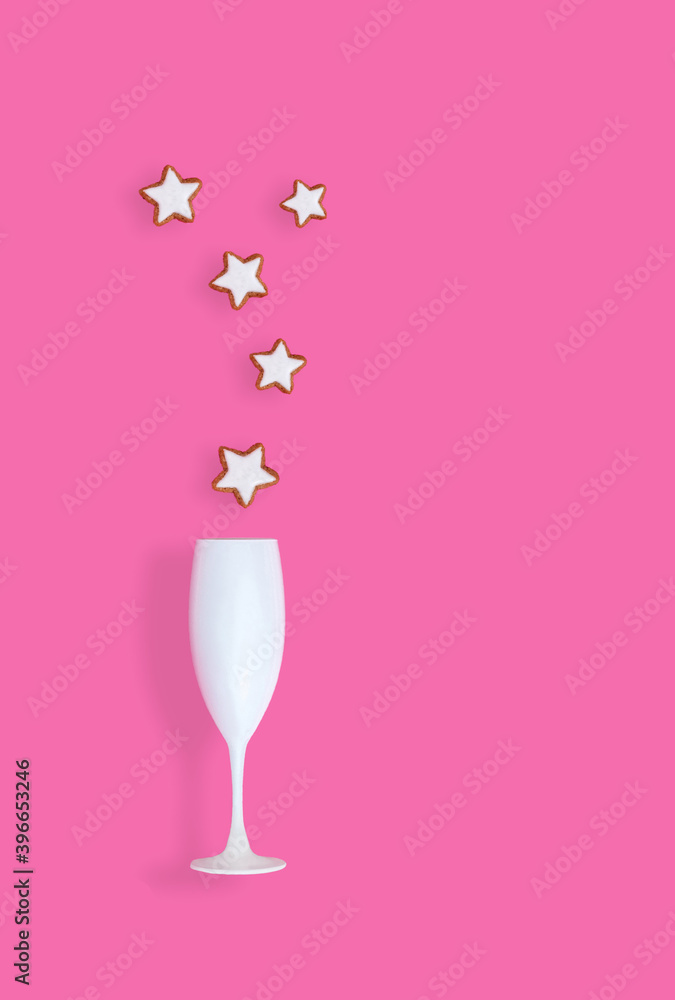 Creative Christmas concept with champaign glass and Christmas cookies on pastel pink background. Flat lay design Creative Christmas concept with champaign glass and Christmas cookies on pastel pink background. Flat lay design