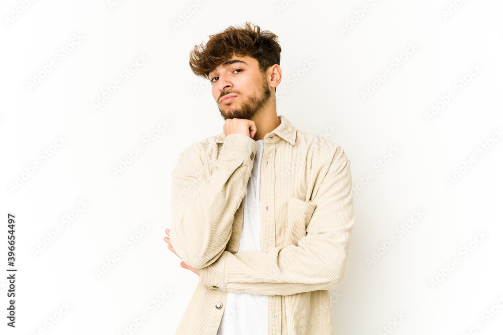 Young arab man on white background suspicious, uncertain, examining you. Young arab man on white background suspicious, uncertain, examining you.