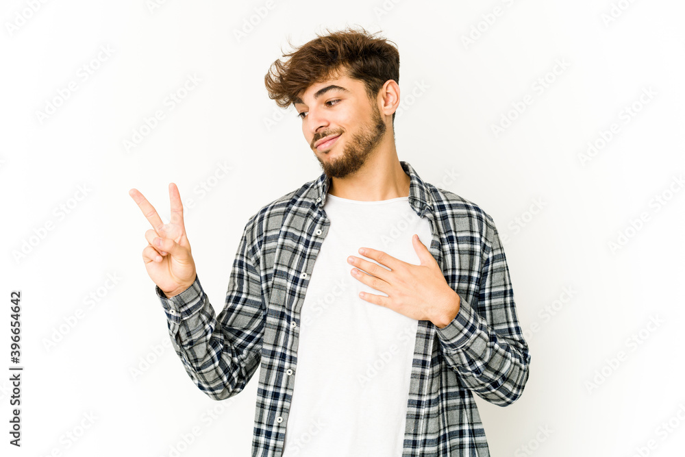 Young arab man on white background taking an oath, putting hand on chest. Young arab man on white background taking an oath, putting hand on chest.