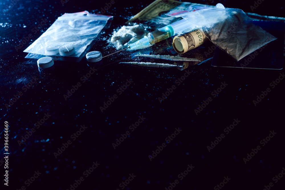 Obraz premium Purchase, possession and sale of drugs is punishable by law. Many types of narcotics and drugs represented on table.