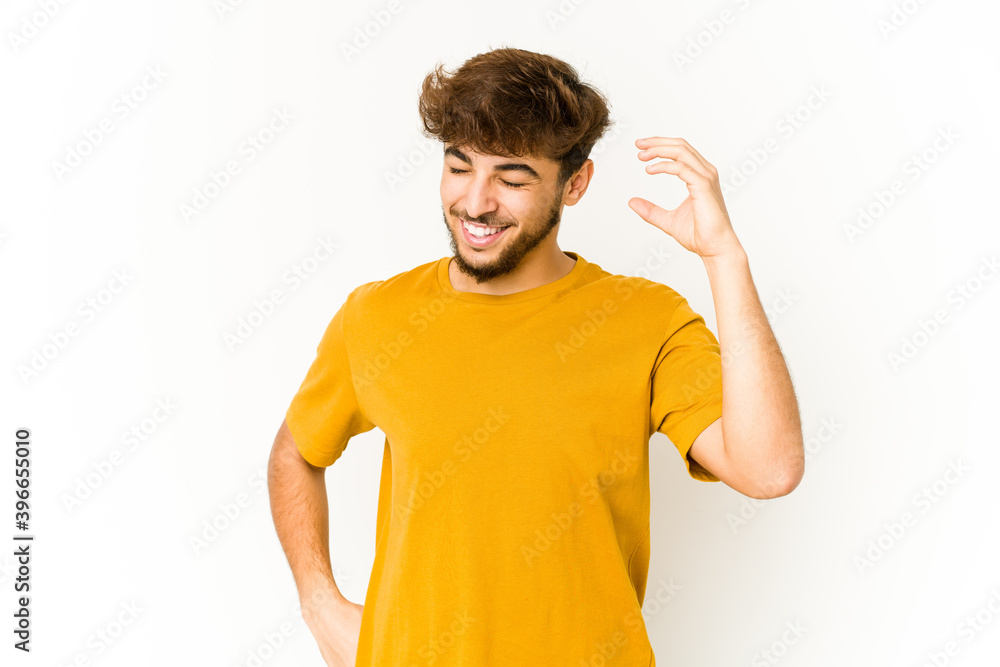 Young arab man on white background joyful laughing a lot. Happiness concept. Young arab man on white background joyful laughing a lot. Happiness concept.