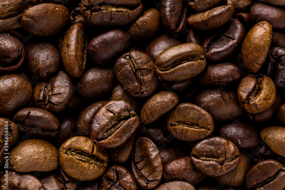 Fototapeta premium Fresh roasted coffee bean background. Background of roasted coffee beans, top view