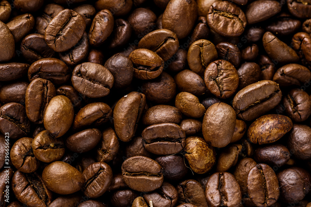 Fresh roasted coffee bean background. Background of roasted coffee beans, top view Fresh roasted coffee bean background. Background of roasted coffee beans, top view