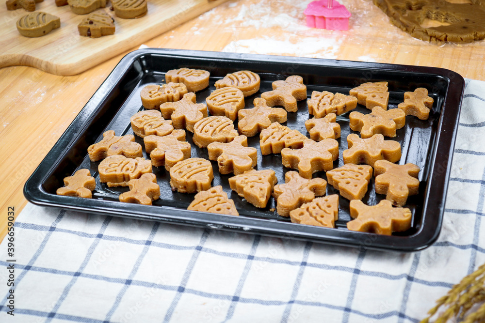Homemade Christmas ginger bread cookies, Xmas gingerbread cookie on tray, preparing bakery, process of baking and cooking at home Homemade Christmas ginger bread cookies, Xmas gingerbread cookie on tray, preparing bakery, process of baking and cooking at home