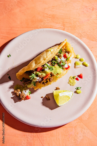 Overhead view of puffy taco served on plate