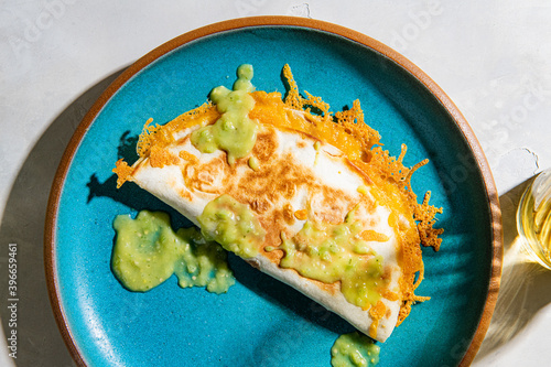Overhead view of bean and cheese quesadilla garnish with sauce served on plate