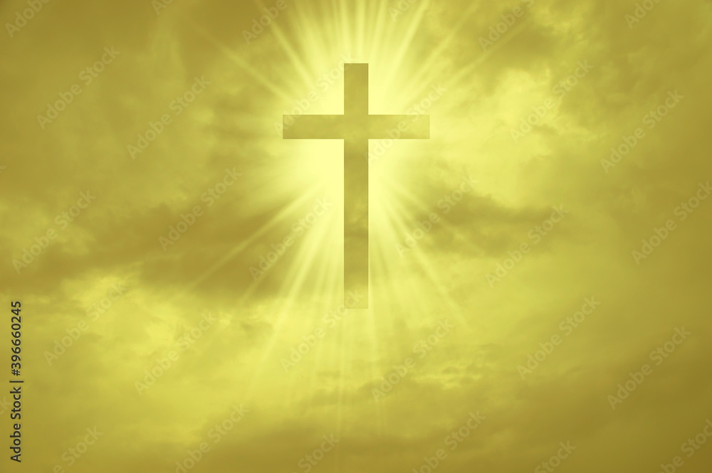 Christian cross appears bright in the yellow sky background