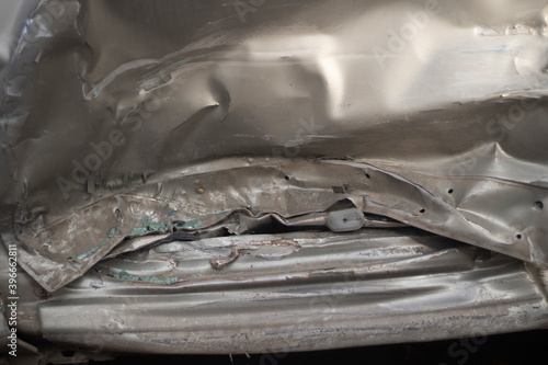 Damaged metal. Shooting a dent on a car after an accident.  photo