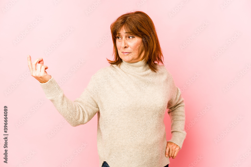 Senior caucasian woman isolated pointing with finger at you as if inviting come closer. Senior caucasian woman isolated pointing with finger at you as if inviting come closer.