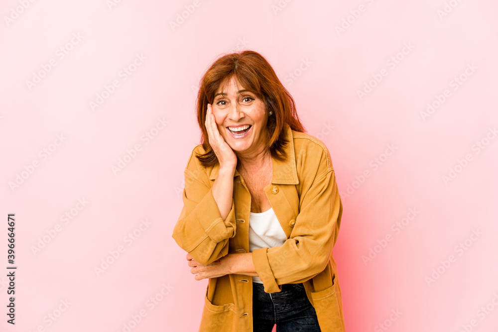 Senior caucasian woman isolated laughs happily and has fun keeping hands on stomach. Senior caucasian woman isolated laughs happily and has fun keeping hands on stomach.