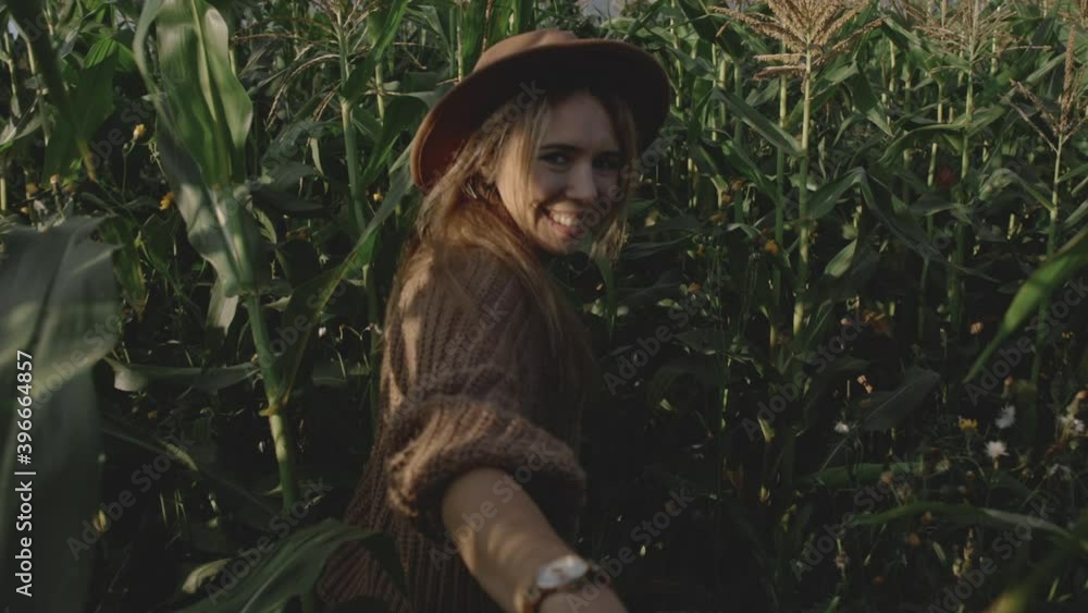 Follow me concept date of young married couple in field or meadow with corn. Romantic meeting of two young people in village, farm or ranch. Slow motion of girl running and holding hand of young man. Follow me concept date of young married couple in field or meadow with corn. Romantic meeting of two young people in village, farm or ranch. Slow motion of girl running and holding hand of young man.