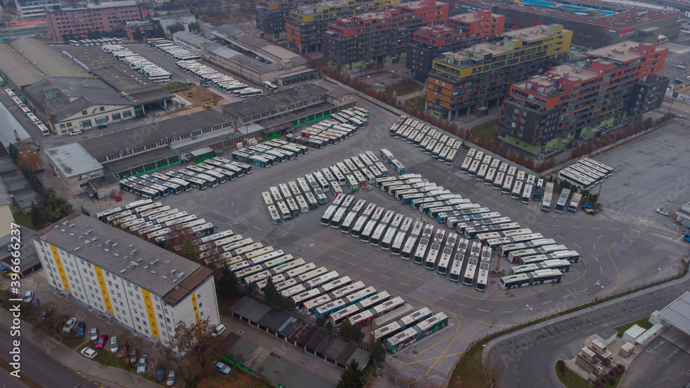 Lockdown due corona virus results also in stopped public transport - showing full bus garage packed with public transport buses. Lockdown due corona virus results also in stopped public transport - showing full bus garage packed with public transport buses.